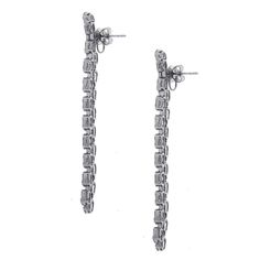 For Sale on 1stDibs - Material: 18k white gold Style: Drop earrings Diamond Details: Approximately 7.25ctw baguette cut diamonds. Diamonds are G in color and VS in clarity.