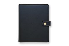 a black notebook with a gold button on the front and side, open to show its cover