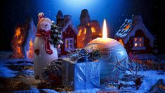 a christmas scene with a snowman and a lit candle