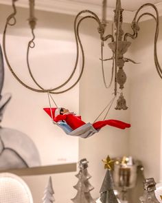 an ornament hanging from the ceiling in a room with christmas trees and other decorations