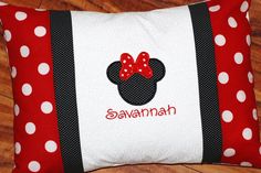 a red and white pillow with a minnie mouse on it's side that says savannah