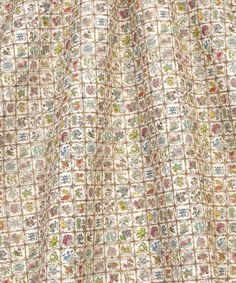 a close up view of a curtain with floral designs on it