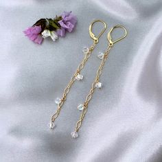 ✦These unique Victorian style romantic earrings have 4mm premium clear aurora borealis bicone crystals that are wire wrapped to a fancy 14k gold filled short and long corrugated cable chain.   ✦The earrings measure about 3 inches in length. All 14k gold filled. The French hook ear wires come with rubber grommets for a secure fit. Also available with lever back ear wires. Please select ear wire style at check out. ✦Click here to see the matching necklace: https://www.etsy.com/listing/1169941660 ✦Your jewelry will be packaged in a beautiful and reusable organza bag. All items will be placed in the same organza bag. If you need a separate bag for each item, please leave a comment at check out. ✦Giving your purchase as a gift? If you would prefer that prices not be printed on your invoice, ple Boho Wedding Jewelry, Romantic Earrings, Bridal Accessory, Diy Jewelry Projects, Jewelry Card, Wedding Jewelry Earrings, Handmade Boho, Matching Necklaces, Chain Earrings