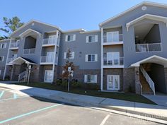 two story apartment building with balconies on the second floor