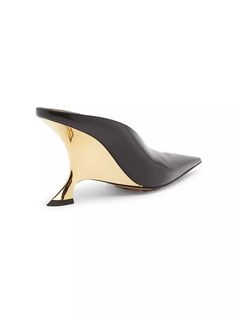 Designed with an intentionally creased exaggerated point toe, Bottega Veneta’s Rocket mules feature a sculpted gold metal heel..Leather upper.Pointed toe.Slip-on style.Leather lining.Padded insole.Rubber sole.Made in Italy.SIZE.Sculpted wedge heel, 3.5' (90mm).This brand fits slightly smaller. Consider ordering a size up..ABOUT THE BRAND.Founded in 1966, the label known for fine Italian craftsmanship with creativity at its core has since catapulted to cult-level status. The house's storied intrecciato pattern in shoes and handbags, alongside its signature minimalist ready-to-wear, have made the label an editor and It-girl favorite..Designed with an intentionally creased exaggerated point toe, Bottega Veneta’s Rocket mules feature a sculpted gold metal heel.Leather upperPointed toeSlip-on s Gold Calf Leather Heels With Pointed Toe, Modern Gold Heels With Contrasting Heel Counter, Gold Heels With Deep Heel Cup In Modern Style, Modern Gold Heels With Deep Heel Cup, Chic Gold Calf Leather Heels, Gold Open Heel Calf Leather Heels, Gold Calf Leather Heels For Party, Gold High Heel Calf Leather Heels, Gold High Heel In Calf Leather