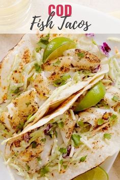 fish tacos on a plate with guacamole and salsa in the background