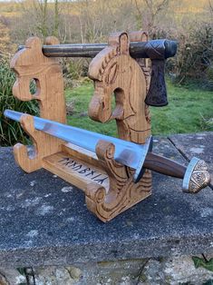 Show off your sword with a statement piece that's truly one-of-a-kind. My hand-carved sword stand is custom-made from ethically-sourced local hardwood, giving it an authentic feel you wont find in mass-produced designs.  I can do any design from any era or theme from Templar knights to Anime. Viking Sword Display Stand: Hardwood - dependent on availability due to all ethically and locally sourced. Typically Oak, Ash or Beech. 40x40x20cm Free standing. Holds 4 swords or axes If you need a matchin Viking Wood Projects, Viking Carving, Celtic Forest, Viking Gifts, Templar Knights, Vikings Gifts, Viking Ship, Camping Items, Viking Art