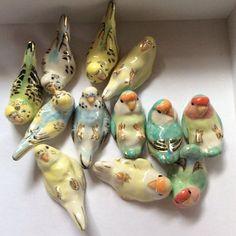 small ceramic birds sitting in a white box