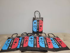 four bags with different designs on them sitting on top of a couch next to each other