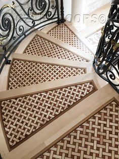 a spiral staircase with decorative wood treading and wrought iron railing