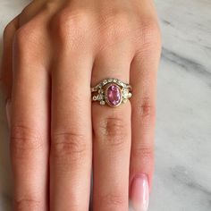 A vibrant Pink tourmaline is set in Emily's 14k gold Trefoil cluster setting with a freeform band. We originally saw this as being a unique engagement ring but it would be just as wonderful as an everyday bit of sparkle and looks phenomenal with our halo bands Approximate stone size: 9mm x 7mm TCW tourmaline: 1.2ct TCW diamonds: .12ct Mohs Stone Hardness: 7.5-8 This one of a kind piece is handmade with love in Emily's Hudson Valley studio. If you have questions about sizing, shipping or need hel Heirloom Pink Sapphire Ring, Fine Jewelry Rings With Rose Cut Diamonds And Tourmaline, Vintage Tourmaline Ring For Anniversary, Yellow Gold Tourmaline Rings With Rose Cut Diamonds, Vintage Tourmaline Anniversary Ring, Heirloom Oval Tourmaline Ring, Wedding Rings With Rose Cut Diamonds And Tourmaline, Tourmaline Rings With Rose Cut Diamonds For Anniversary, Halo Band