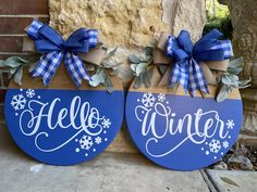 two wooden signs that say hello winter