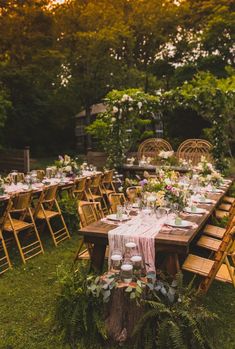 an outdoor table set up for a wedding reception