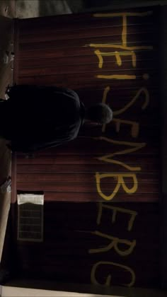 a man riding a skateboard down the side of a wooden ramp with graffiti on it