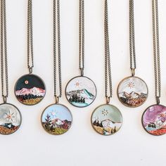 six necklaces with different designs on them