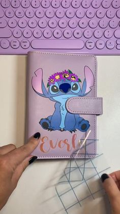 the stitch book is being held up by someone's hand