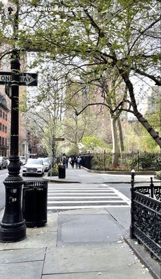 the street sign is clearly visible for all to see on this busy city street corner