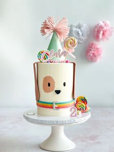 a birthday cake decorated with candy, lollipops and a dog's head