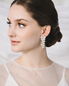 "BIANCA PEARL EARRINGS (JE-4463) Complete your bridal look with our Bianca Pearl Earrings. With a hand wired, dangle design, sparkling round crystals, and lustrous round pearls, these earrings embody elegance and sophistication. Perfect for the stylish bride seeking a touch of luxury on her special day.  DETAILS * White pearls and crystal beads * 2\" length * Hypoallergenic, lead-free & nickel-free * Style #4463 SHOP MORE STYLES https://www.etsy.com/shop/darethcolburndesigns NEED MORE HELP? Happy to offer advice or recommendations, just message me!" Wedding Earrings Pearl, Bridal Drop Earrings, Crystal Wedding Earrings, Pearl Earrings Designs, Drop Earrings Wedding, Pearl Bridal Earrings, Crystal Comb, Pearl Statement Earrings, Sparkle Design