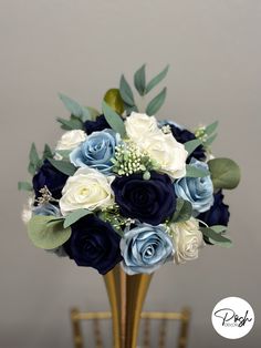 a blue and white bouquet in a gold vase