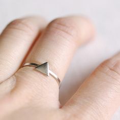 "A simple triangle ring with a modern silhouette. Pictured are our gold triangle ring stacked with our silver triangle ring, almost interlocking for a unique two tone effect. Tumble polished for hours to achieve a satin finish. Looks super cute worn alone or stacked (as shown). MATERIALS tarnish resistant rhodium silver filled/14k gold filled DIMENSIONS triangle measures about 4x4mm (about 5/32\" x 5/32\") ◊ Matching triangle jewelry: https://www.etsy.com/shop/kindlingandco/search?search_query=t Minimalist Sterling Silver Stackable Rings, Minimalist Adjustable Stackable Rings, Adjustable Minimalist Midi Rings, Jewellery Minimal, Triangle Jewelry, Minimalist Jewellery, Triangle Ring, Gold Triangle, Ring Minimalist