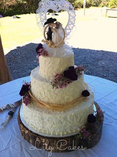 a wedding cake with a bride and groom figurine sitting on top of it