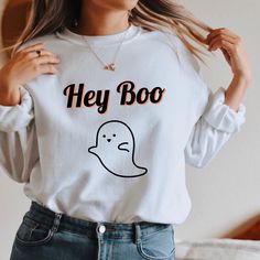 Hey Boo! No tricks here, just a cute ghostly sweatshirt to cozy up in this fall. Printed on a soft on the inside, preshrunk cotton, polyester unisex crewneck sweatshirt. Order 1 or two sizes up for an oversized look and fit. Free shipping for U.S. orders *PLEASE READ INSTRUCTIONS BEFORE PURCHASING* PLACING YOUR ORDER * Choose your Sweatshirt color * Choose your size * PLEASE make sure all your order's steps are complete. PRODUCT DETAILS A sturdy and warm sweatshirt bound to keep you warm in the White Fun Sweater For Fall, Fun White Sweater For Fall, Funny Long Sleeve Sweatshirt For Fall, Casual White Sweatshirt For Halloween, Cute Halloween Sweatshirt With Letter Print, Trendy White Halloween Sweatshirt, White Long Sleeve Halloween Sweatshirt, Cute Halloween Sweatshirt With Long Sleeves, Cute Halloween Long Sleeve Sweatshirt