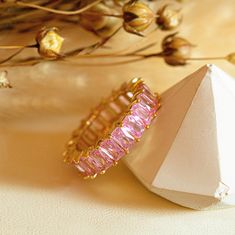 P I N K *  S T O N E *  R I N G Gold ring band with sparkling Cubic Zirconia stones in a beautiful pink shade.  It's perfect for adding a pop of colour to your everyday outfits this season and guarantees to make an excellent base for any ring stack. Also available in other colours. * Material: High Quality Solid 925 Sterling Silver plated with 18 Carat Gold * Thickness: 5mm * Stone Colour: Pastel Pink * Hypoallergenic, water-safe and tarnish-resistant O T H E R ∙ I N F O R M A T I O N   * All it Pink Eternity Band Ring As Gift, Pink Cubic Zirconia Eternity Band As Gift, Gold Ring Band, Colour Pastel, Colourful Jewellery, Very Nice Pic, Pink Stones, Statement Jewellery, Stacked Jewelry