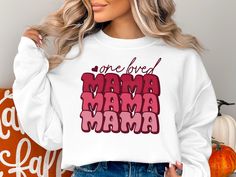 "Embrace the warmth and love with our \"One Loved Mama\" graphic sweatshirt - a perfect Mother's Day gift or birthday present for the treasured mom in your life. Made with soft, high-quality materials, this versatile piece can be enjoyed as a cozy hoodie or a casual t-shirt, ensuring your mom feels both comfortable and cherished every day. Whether she's running errands or relaxing at home, this thoughtful sweatshirt will remind her of how much she's loved. Hoodie - Gilden 18500 This unisex heavy blend hooded sweatshirt is relaxation itself. Made with a thick blend of cotton and polyester, it feels plush, soft and warm, a perfect choice for any cold day. In the front, the spacious kangaroo pocket adds daily practicality while the hood's drawstring is the same color as the base sweater for e Graphic Print Sweatshirt For Birthday And Mother's Day, Cheap Graphic Print Sweatshirt For Mother's Day, Casual Text Print Sweatshirt For Mother's Day, Mother's Day Graphic Print Sweatshirt, Cute Mother's Day Crew Neck T-shirt, Mom Hoodies, Unique Mothers Day Gifts, Mom Birthday, Best Mom