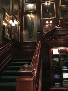 the stairs are lined with paintings and pictures