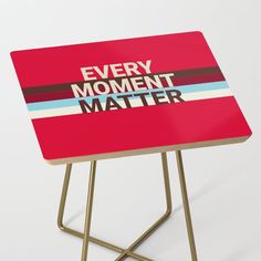 a small red table with the words every moment matters matter on it's top