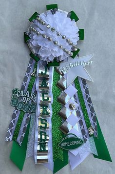 a green and white christmas tree made out of scrapbook pages with ribbons, bows, and decorations