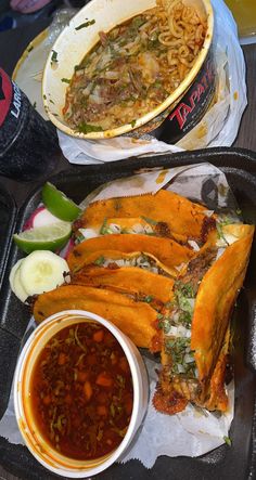 two trays filled with food on top of a table