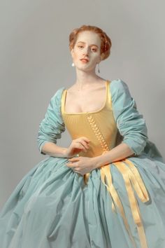 a woman in a blue and yellow dress