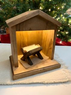 a small wooden bench sitting in front of a christmas tree