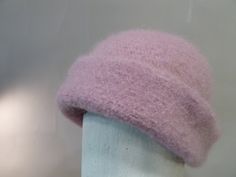 "Warmest ever wool and mohair hat is knit  in luscious pale pink yarn, then felted for a soft, dense fabric that resists wind and moisture. Fifteen per cent mohair for brushed texture. Styled to fold up for double layer over ears. Sizing is medium, measures 26 \" around, and 12\" top to bottom. When folded up measures about 9\". Ultimate dog walking hat." Pink Soft Knit Cap, Pink Winter Felt Hat With Short Brim, Pink Short Brim Felt Hat For Winter, Winter Pink Short Brim Felt Hat, Pink Winter Felt Hat With Curved Brim, Pink Curved Brim Felt Hat For Winter, Pink Felt Hat With Curved Brim For Winter, Mohair Hat, Felted Hat