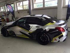 a car painted with black, yellow and white designs