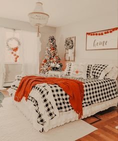 a bedroom decorated for christmas with a tree in the corner