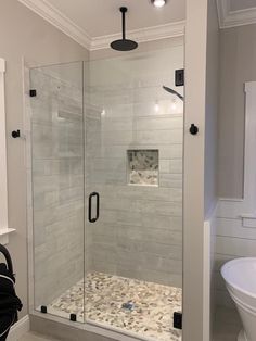 a walk in shower sitting inside of a bathroom