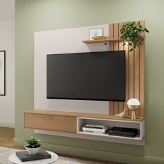 a flat screen tv sitting on top of a wooden entertainment center next to a plant