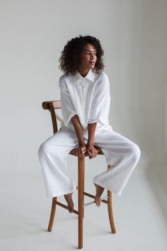 a woman sitting in a chair with her legs crossed