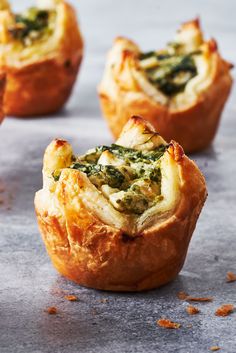 several mini quiches with spinach and cheese in them