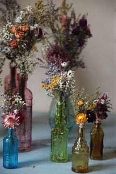 three vases filled with different types of flowers