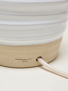 a close up of a white bowl with a cord attached to the top and bottom