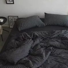 a bed with black and white striped sheets