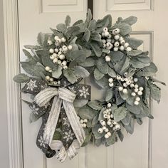 Winter/Christmas lamb's ear wreath for front door with white berries in an all around design, would also look beautiful on your wall or mantel.  The bow features gray and white  plaid faux dupioni silk and white and silver snowflake ribbons.   Finished size is 24" h x 24" w x 8" d. Suitable to use late fall through Christmas and into winter. Comes with hanger attached, ready for hanging. Your wreath may be used outside but it will have the longest lifespan if protected from the weather. Each wre Winter Wreath For Front Door, Christmas Lamb, Lamb's Ear, White Berries, Lambs Ear Wreath, Dupioni Silk, Late Fall, Lambs Ear, Silver Snowflakes