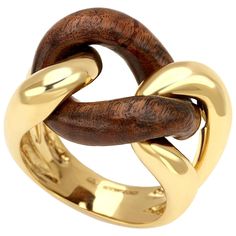 Description: This exquisite groumette ring combines the luxurious appeal of 18 karat yellow gold with the durability and rich texture of rose wood. Known as one of the most resistant and precious woods, rose wood adds a unique and elegant touch to this piece. Part of the iconic Micheletto collection, this ring was originally crafted solely in gold. Over the past decade, the inclusion of wood has become increasingly popular, adding a contemporary twist to the classic design. Material: 18 Karat Ye Cheap Statement Rings In Yellow Gold, Luxury Elegant Rings With Tarnish Resistant, Luxury Fine Jewelry Gold Plated Rings, Cheap Yellow Gold Statement Rings, Luxury Gold Plated Jewelry With Ring Detail, Luxury Artisan Rings For Formal Occasions, Luxury Gold Stackable Rings From Recycled Gold, Cheap Elegant Rings With Polished Finish, Luxury Gold-tone Statement Rings