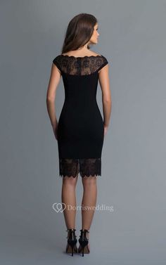 the back view of a woman wearing a black dress with lace detailing and open shoulders