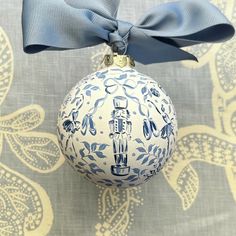 a blue and white ornament with a bow on it