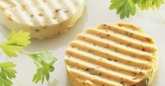 two crackers sitting next to each other on top of a white surface with green leaves